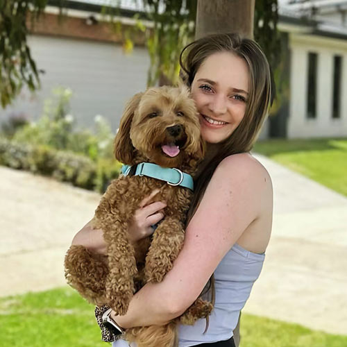 Brea holding a fluffy brown dog