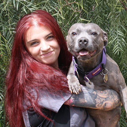Natascha holding a happy pit bull dog